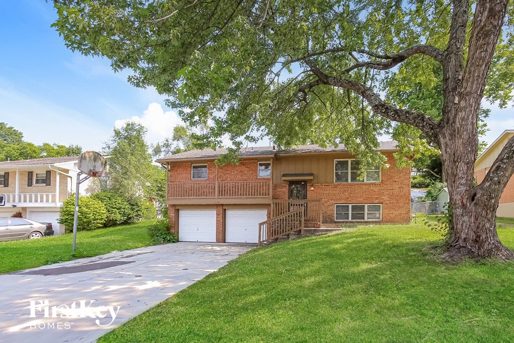 A house with a tree in front of it.