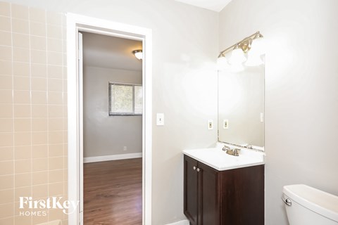 A bathroom with a white sink and a white tub.