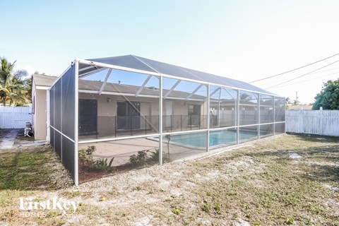 A modern house with a pool in the backyard.