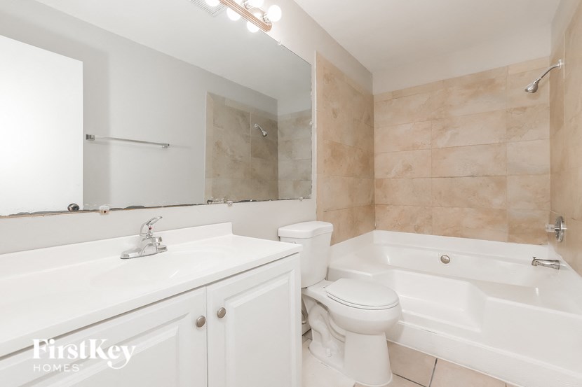 a bathroom with a sink toilet and a bath tub