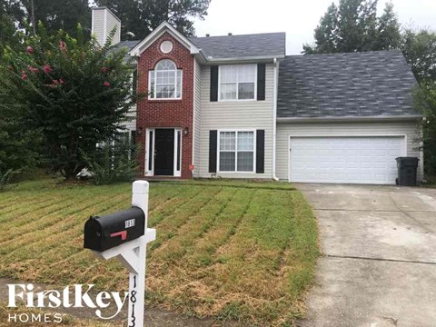 A brick house with a mailbox in front of it.