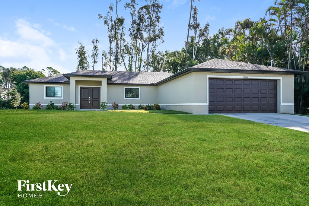 a home with a large lawn and a garage