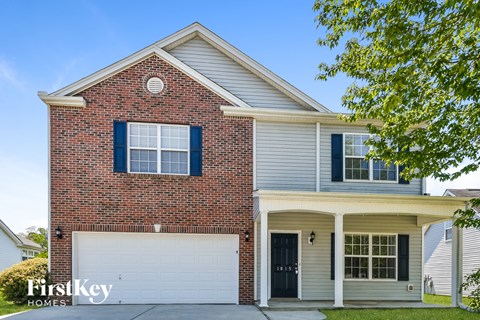a brick house with a white garage door