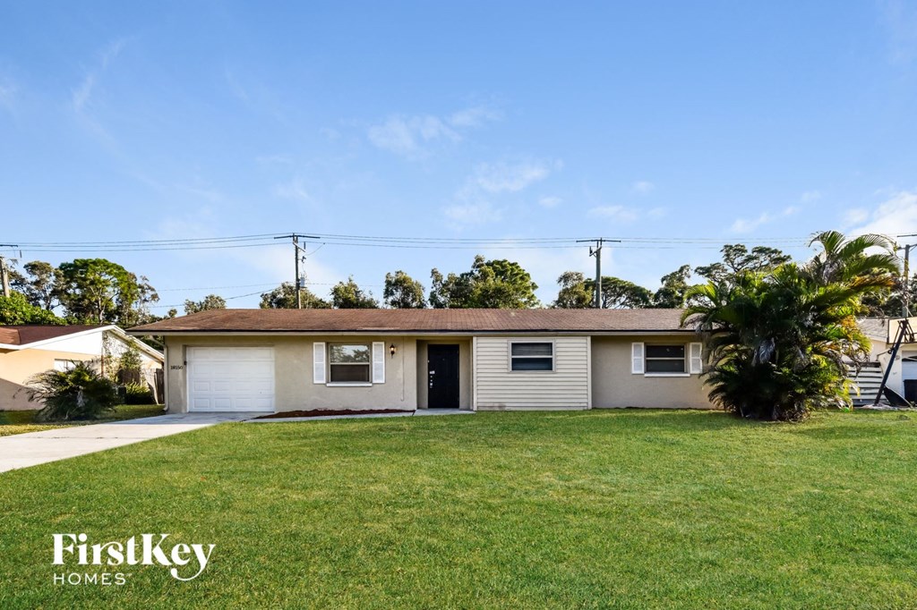 A house with a lawn in front of it.