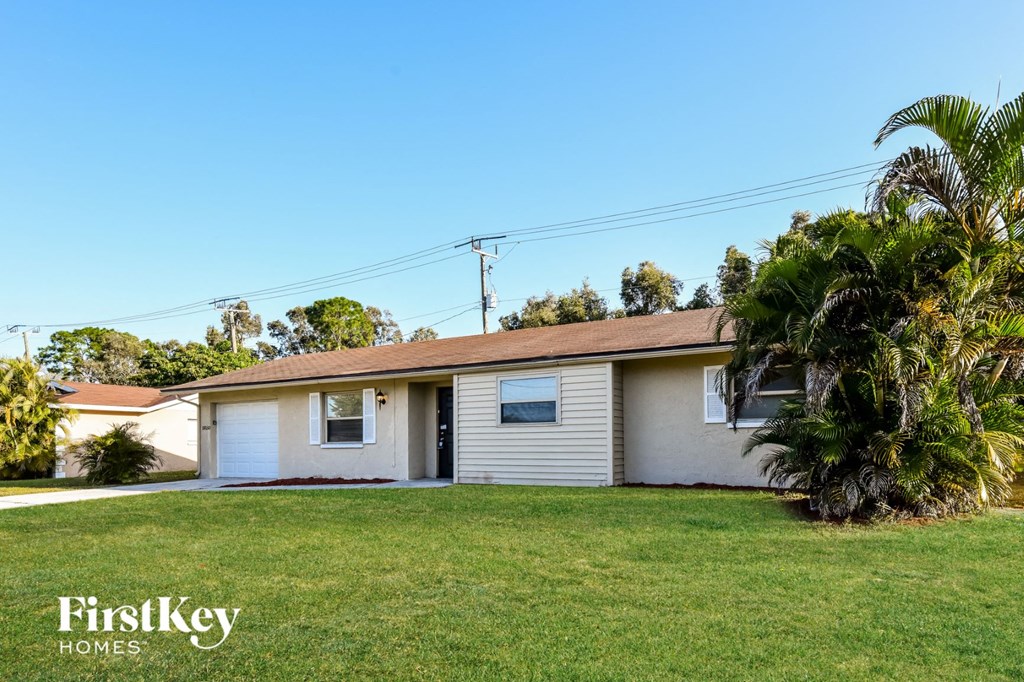 A house with a palm tree in front of it.