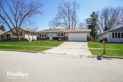 a home with a driveway and a white garage door