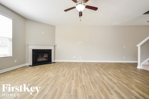 the living room has a fireplace and hardwood floors