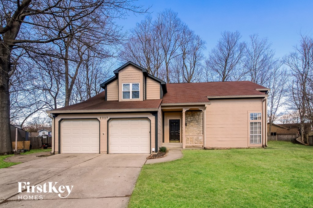 A house with a brown roof and a garage door is for sale.