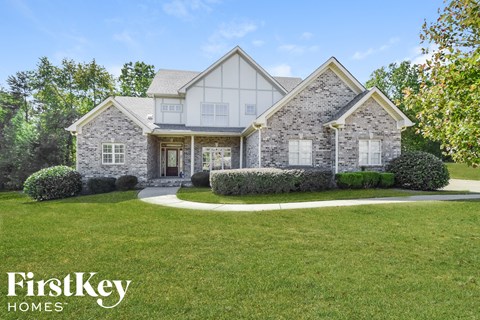 A house with a lawn in front of it and the words "FirstKey Homes" on the bottom.