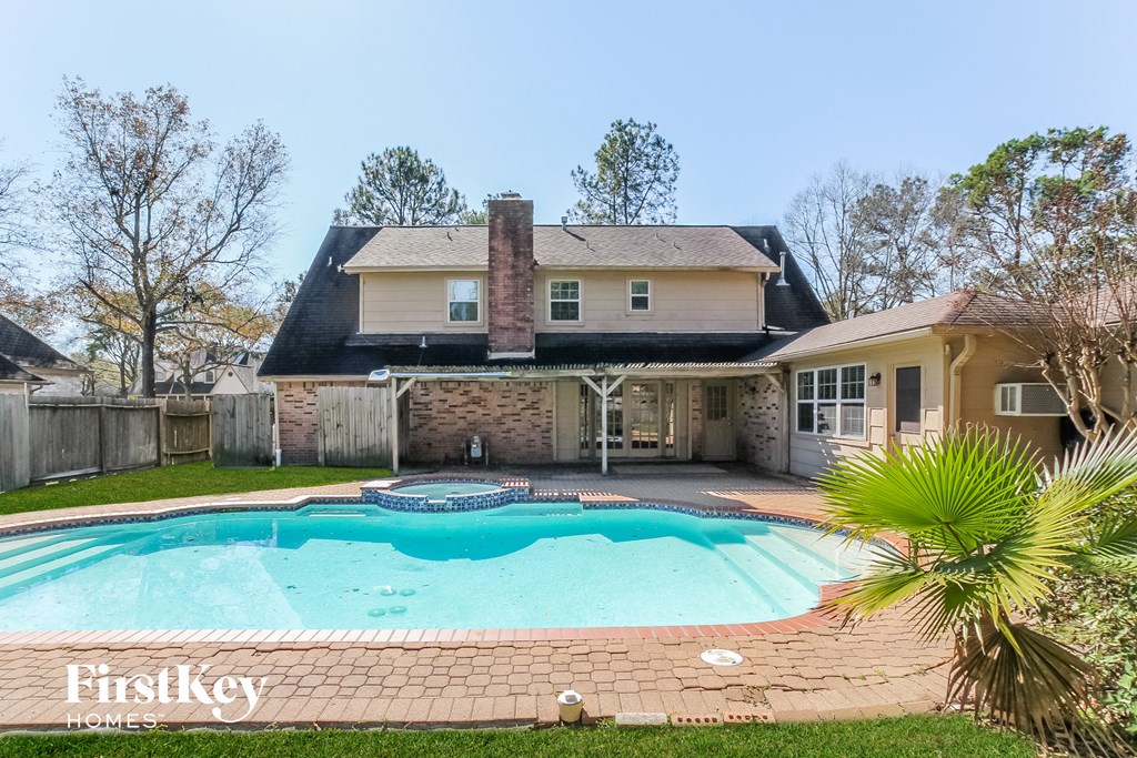 a swimming pool in the backyard of a house with a pool