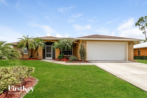 A house with a brown roof and a white garage door.