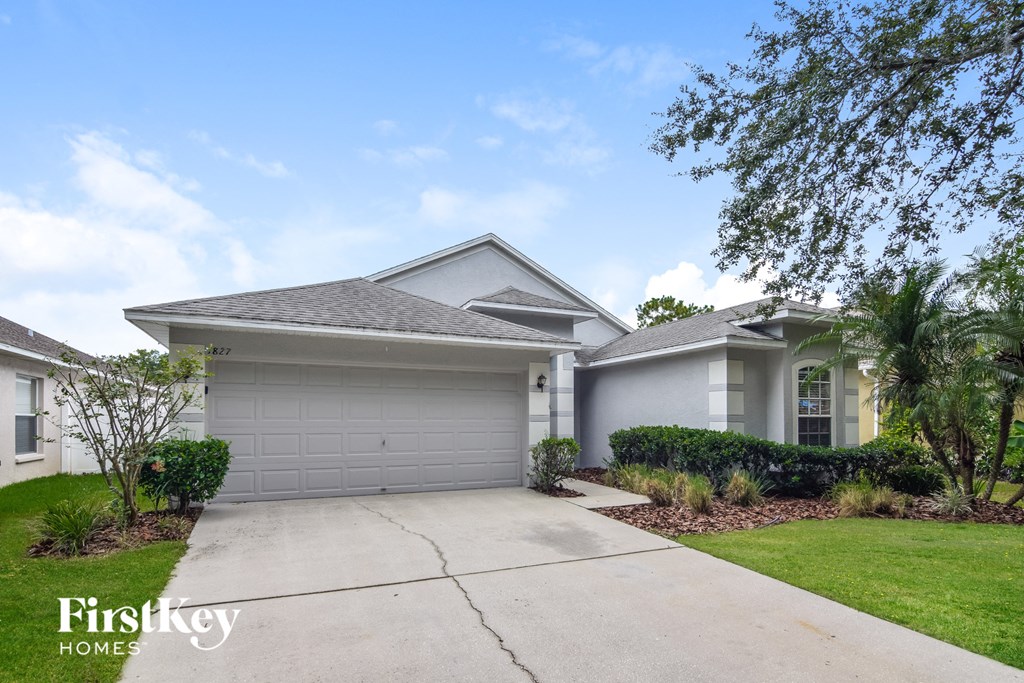 a white house with a driveway and a garage door