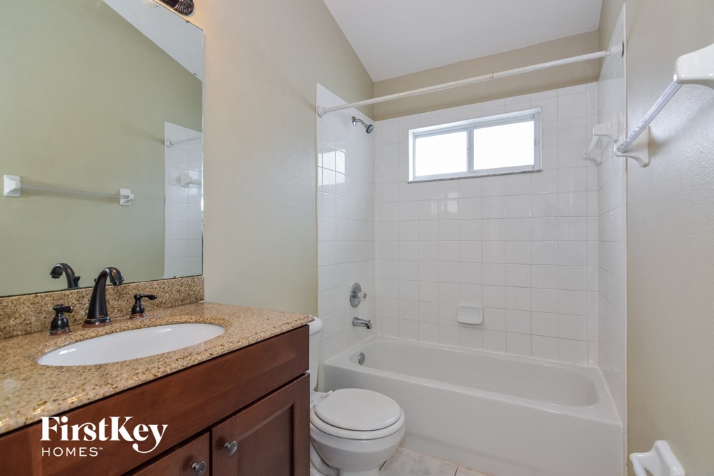 a small bathroom with a shower toilet and sink