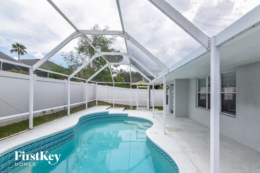 a pool and patio with a glass ceiling and a pool