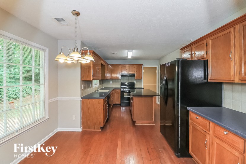 a kitchen with wooden cabinets and black appliances