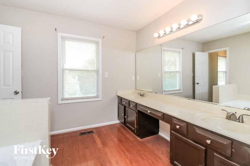 a bathroom with a large mirror and a sink and a toilet