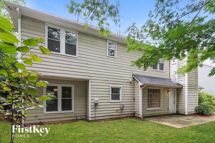 the front of a house with a yard and a backdoor
