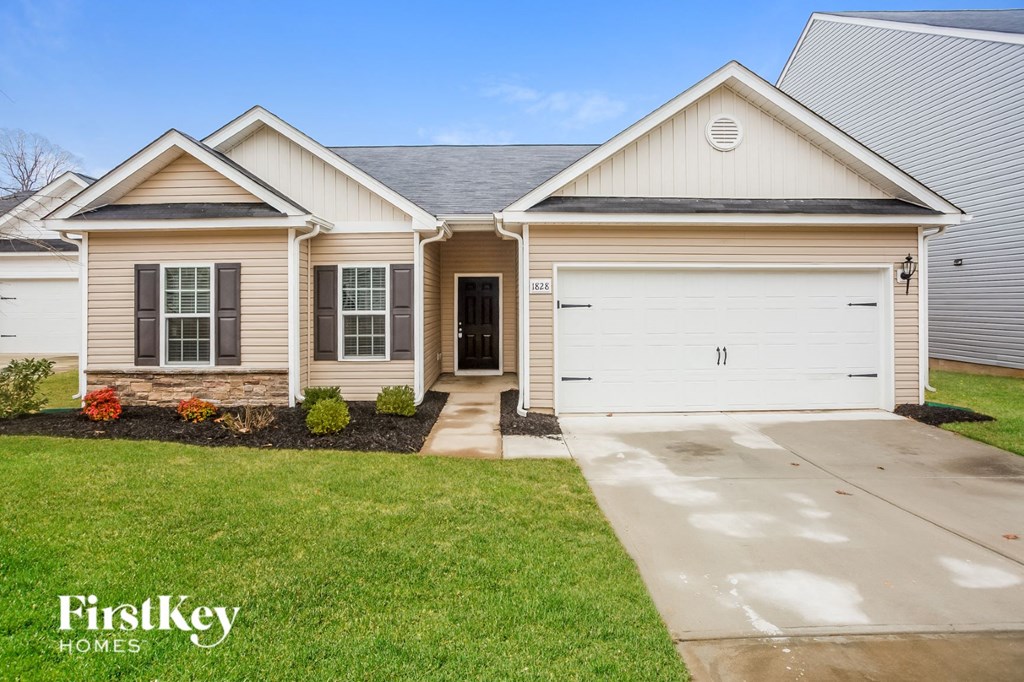 a white and tan house with a white garage door