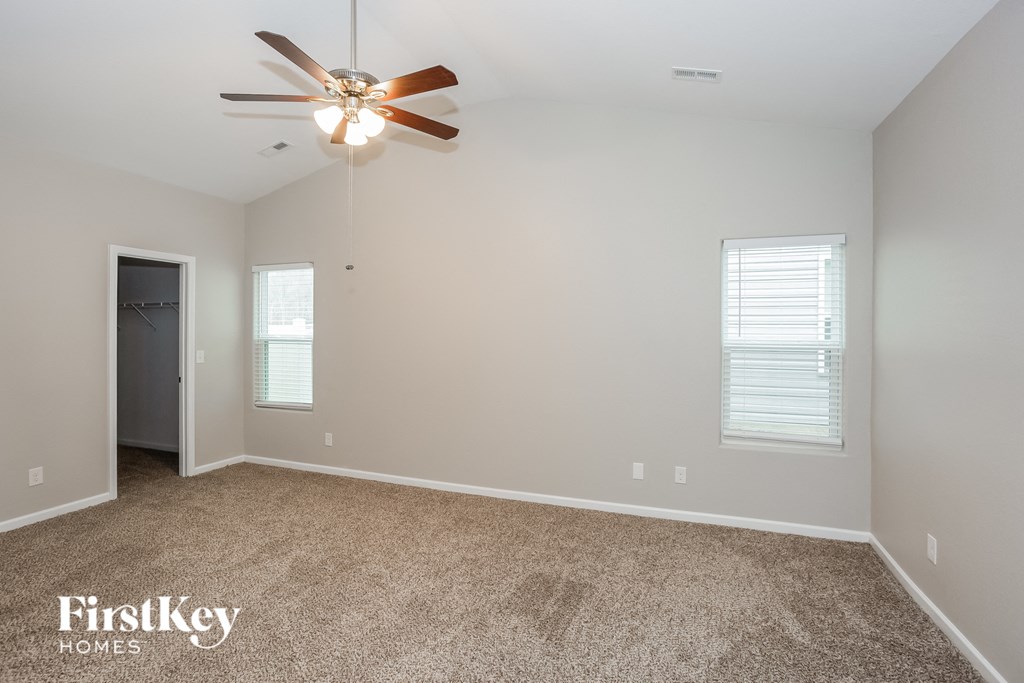 the master bedroom is spacious and has a ceiling fan