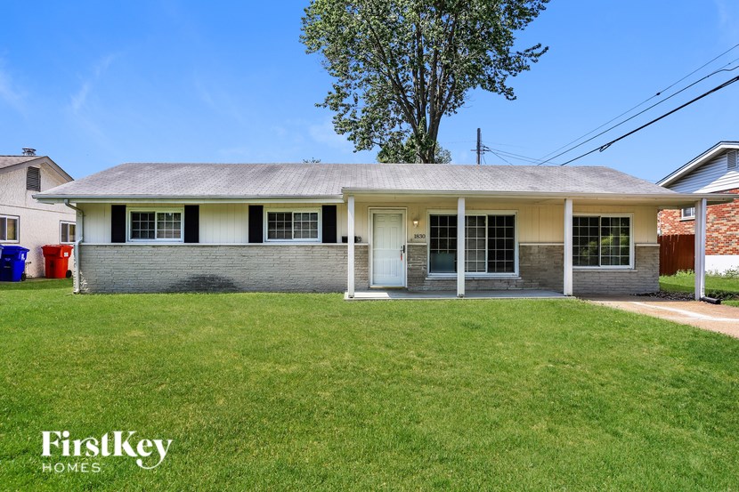 A house with a lawn in front of it.