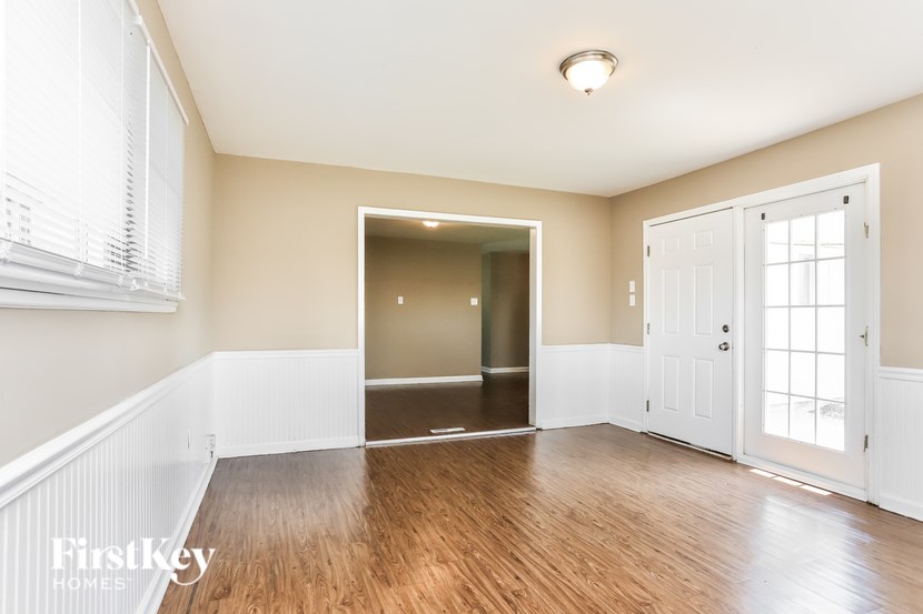 A room with wooden floors and a white door.