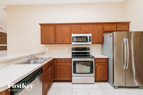 a kitchen with wooden cabinets and stainless steel appliances