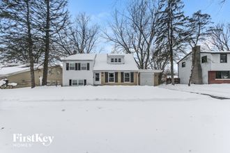 a white house with snow on the ground