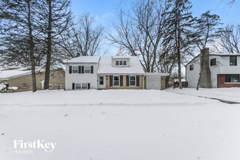 a white house with snow on the ground