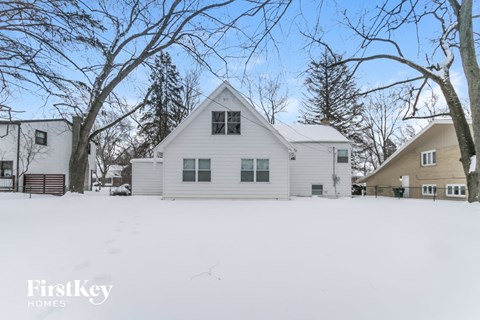 a white house with snow on the ground