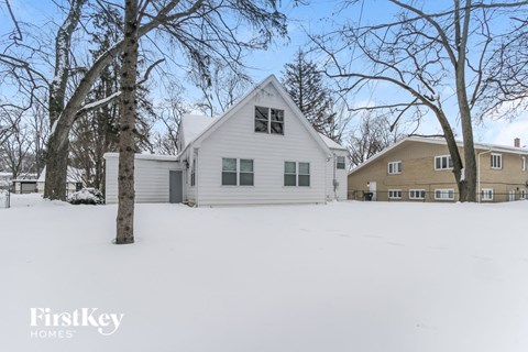 a white house with snow on the ground