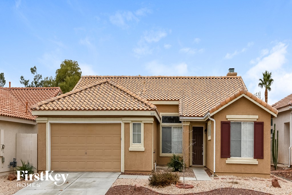 A house with a brown roof and a garage door.