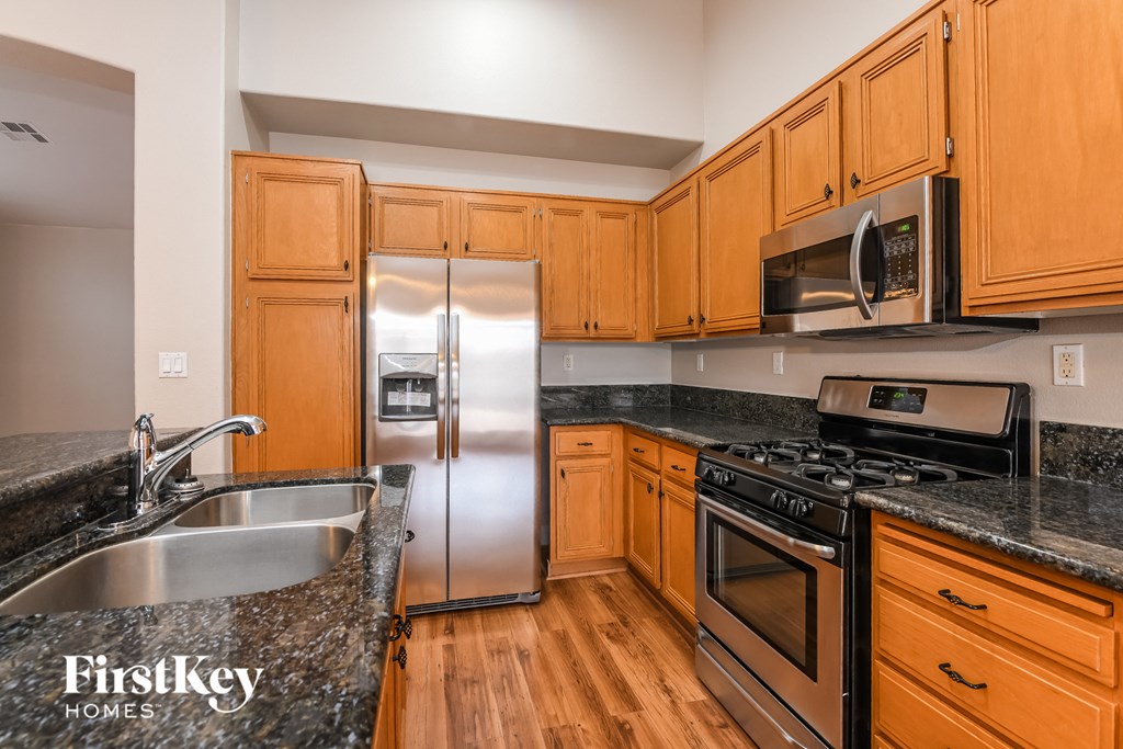 A kitchen with wooden cabinets and stainless steel appliances.