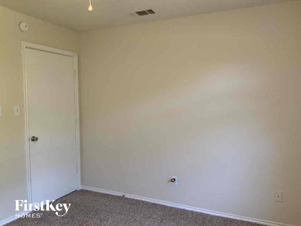 a bedroom with a white wall and a door