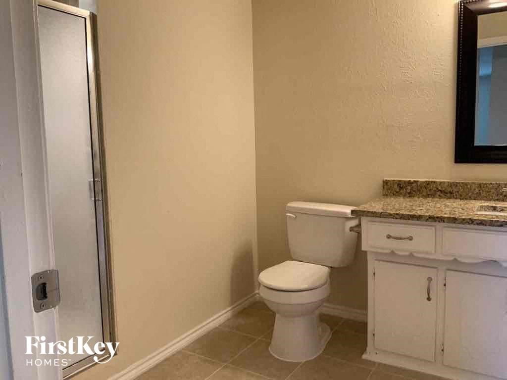a bathroom with a toilet and a sink and a shower