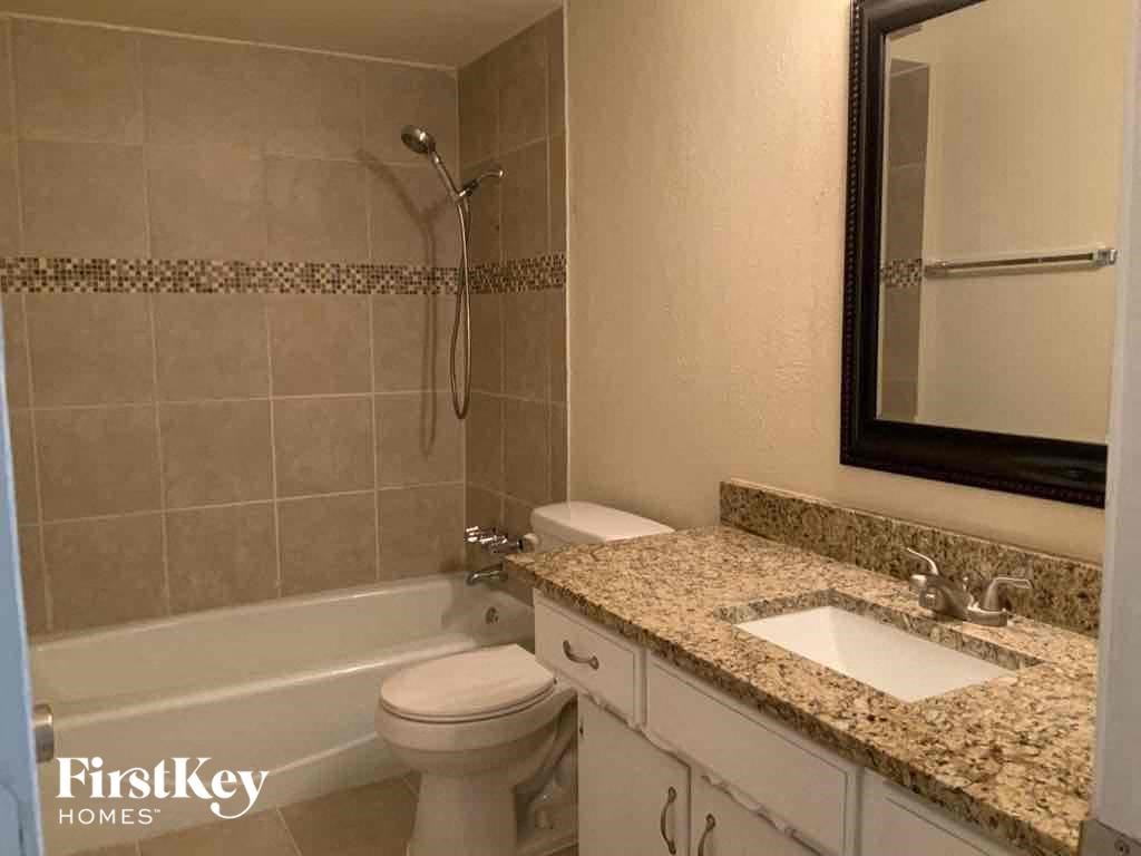 a bathroom with a sink and a toilet and a bath tub