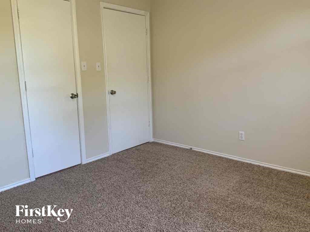 a room with a carpet and two closets