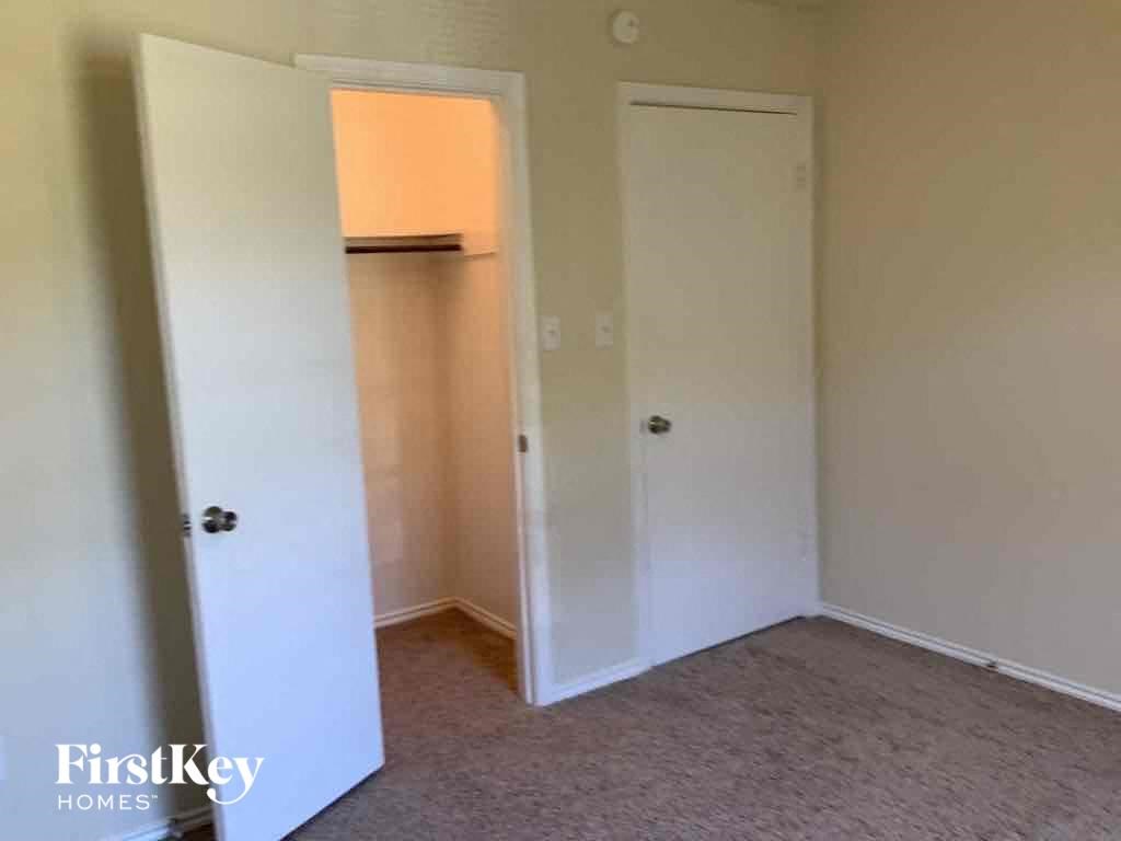 a bedroom with a closet and a door to a closet