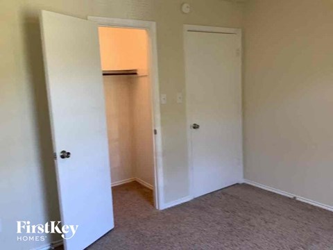 a bedroom with a closet and a door to a closet