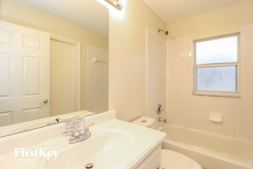 a bathroom with a sink and a tub and a toilet