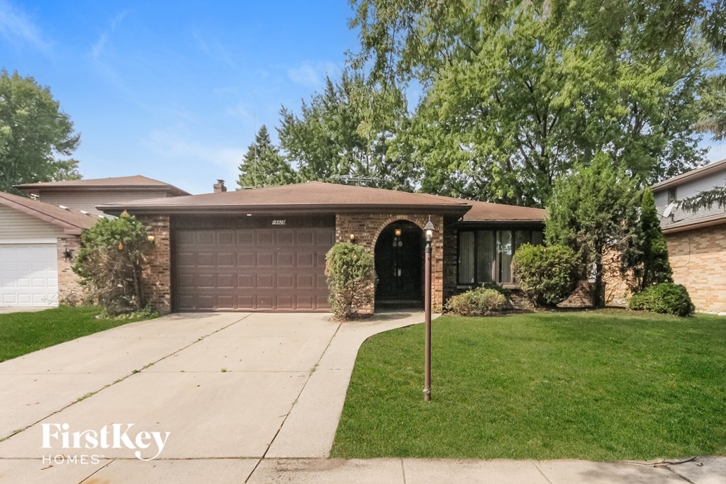A house with a brown garage door is for sale.