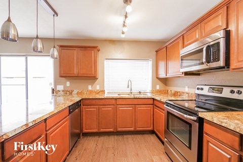 a kitchen with wooden cabinets and stainless steel appliances