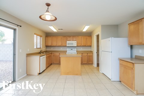 a large kitchen with white appliances and wooden cabinets