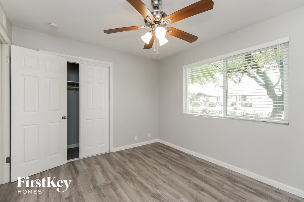 the living room of a home with a ceiling fan and a window