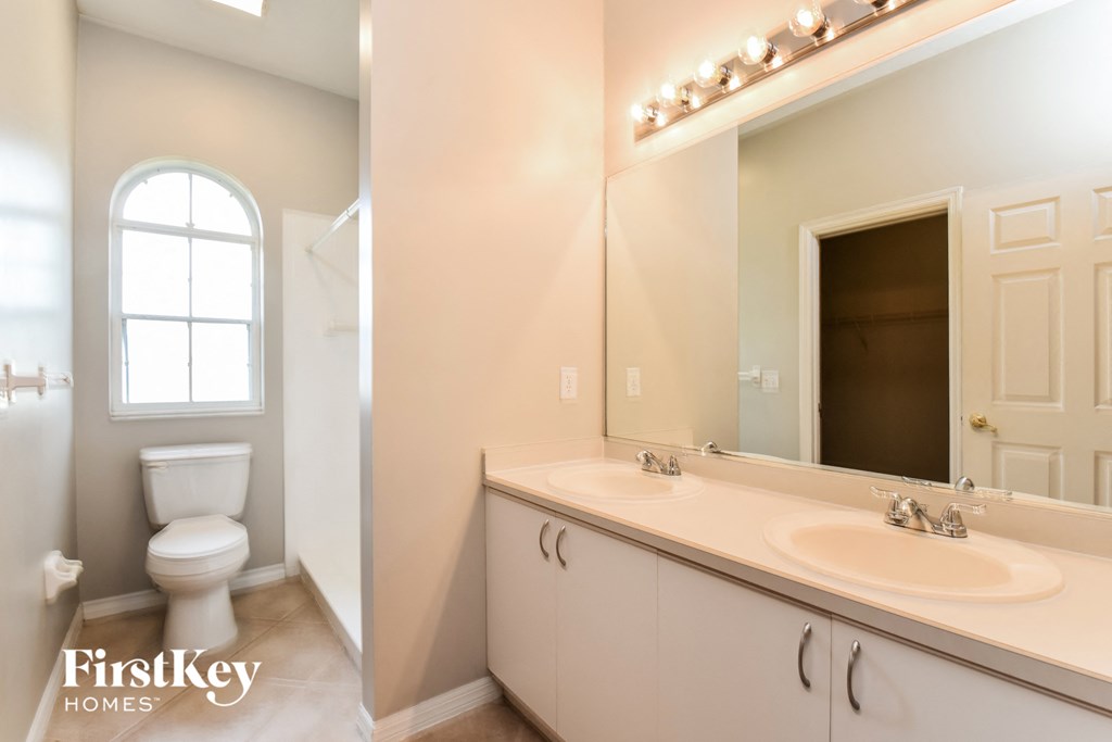 a bathroom with a sink and a toilet and a mirror