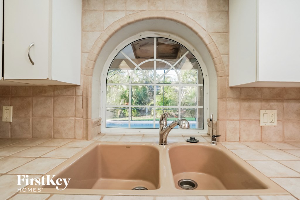 A bathroom with two sinks and a large window.