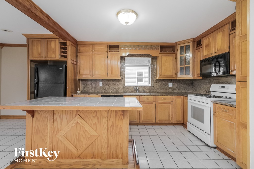 a kitchen with wooden cabinets and white appliances