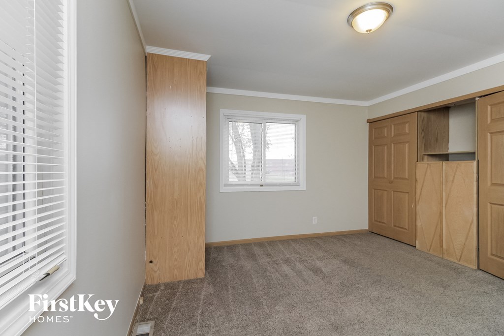 a bedroom with a closet and a window