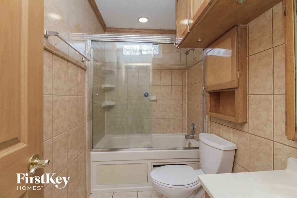 a bathroom with a tub and a toilet and a sink