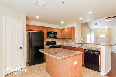 a kitchen with black appliances and a granite counter top