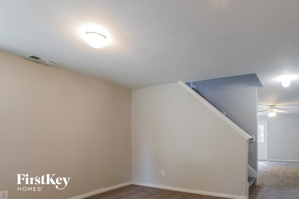 the living room with the staircase leading up to the loft